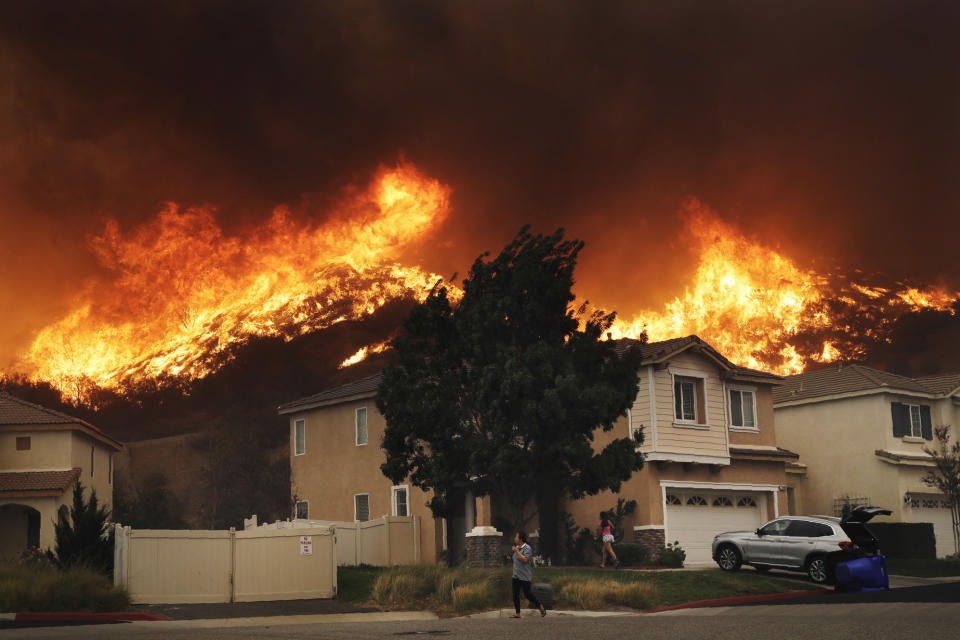 A wildfire approaches a residential subdivision Oct. 24, 2019, in Santa Clarita, Calif. (AP Photo/Marcio Jose Sanchez)