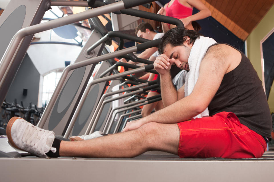 tired person sitting on the treadmill