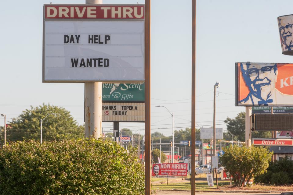 Help wanted signs are seen on restaurants and businesses down N.W. Topeka Boulevard. Worker pay in Kansas is worth less due to inflation this Labor Day.