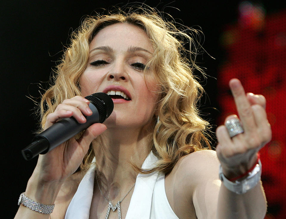 U.S. pop star Madonna performs at the Live 8 concert in Hyde Park in London, July 2, 2005. A galaxy of rock and roll stars will grace stages across the globe on Saturday for what is being billed as the greatest music show ever, in a bid to put pressure on leaders of the Group of Eight major industrialised nations meeting in Scotland next week to do more to alleviate poverty, particularly in Africa. Live 8, an expanded version of the Live Aid sensation 20 years ago, will take in 10 cities and four continents, kicking off in Tokyo in the east and ending in North America in the west. REUTERS/Stephen Hird FR05080003 Pictures of the year 2005  MFK/ASA     Also see image: GF1DUYOLIWAA