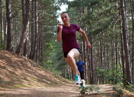 Kosovo's 400 meters runner Vijona Kryeziu runs in the woods of the village Rogane in Kamenica, Kosovo, July 30, 2016. Kryeziu trains in the woods because there was no athletics stadium nearby. The Rio Games will be the first to host athletes competing under the flag of Kosovo. REUTERS/Hazir Reka