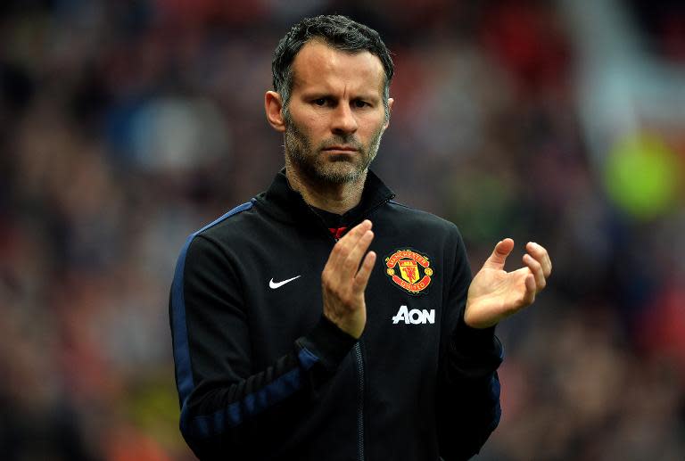 Manchester United's Ryan Giggs applauds before the league match against Hull City at Old Trafford in Manchester, northwest England, on May 6, 2014