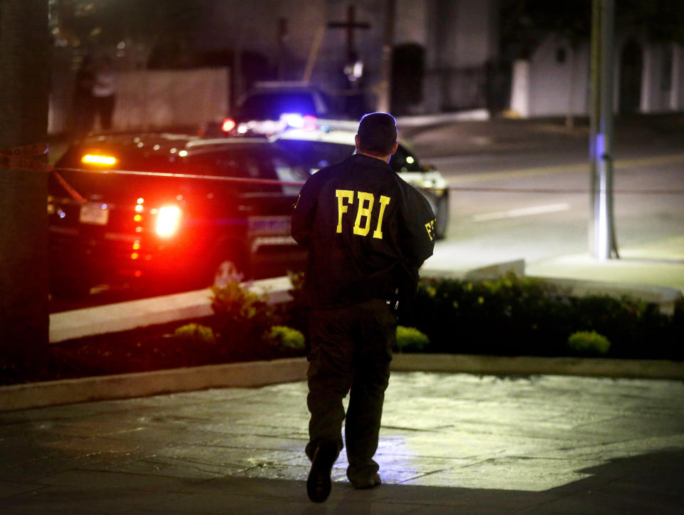 An FBI agent walks across the street from the Emanuel AME Church following the shooting. (AP Photo/David Goldman)