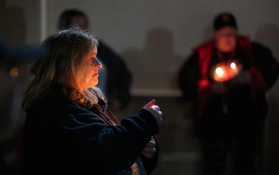Alisha Walker holds a candle in memory of her son Jacob Atwood during the “The Longest Night” vigil at The Salvation Army’s Berberian shelter in Modesto, Calif., Thursday, Dec. 21, 2023. The event was one of many held in communities nationwide as part of the annual the National Homeless Persons’ Memorial Day, which takes place on the winter solstice. Walker said her son was struck and killed by a train in Modesto.