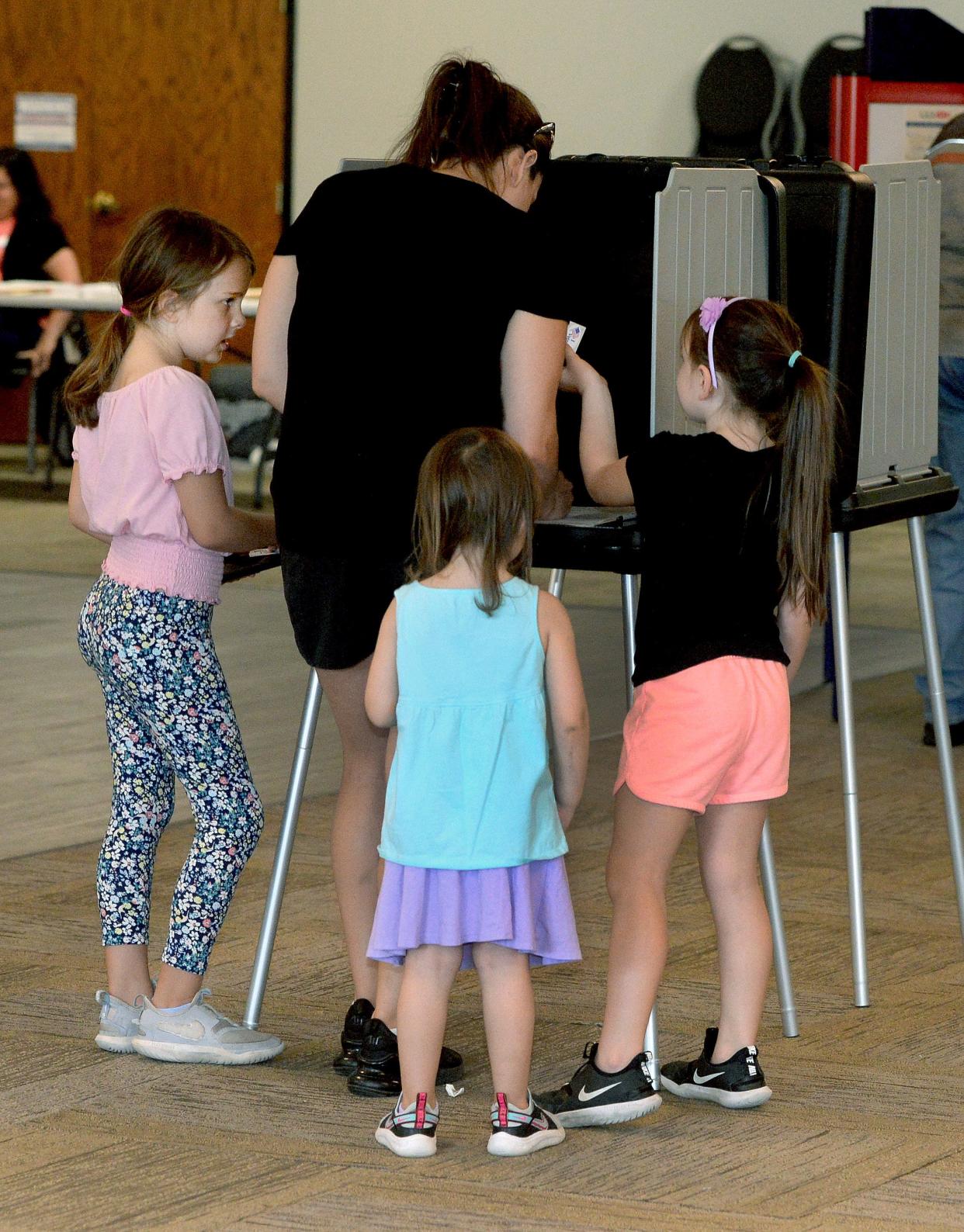 Chloe Leischner, center, is surrounded by her three daughters, left to right, Zoey Oliver, 8, Alli Oliver, 3, and Lily Oliver 6, all of Springfield, as Leischner votes in Tuesdays primary at the Knights of Columbus Hall June 28, 2022.