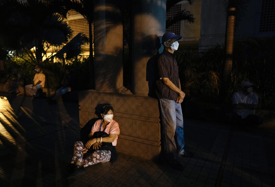 FILE - In this Sept. 17, 2021, file photo, residents wait at dawn outside a vaccination center in hopes of getting a second shot of the Sputnik V COVID-19 vaccine in Caracas, Venezuela. Millions from Latin America to the Middle East are waiting for promised doses of the Russian-made Sputnik V coronavirus vaccine due to manufacturing problems and other issues. (AP Photo/Ariana Cubillos, File)