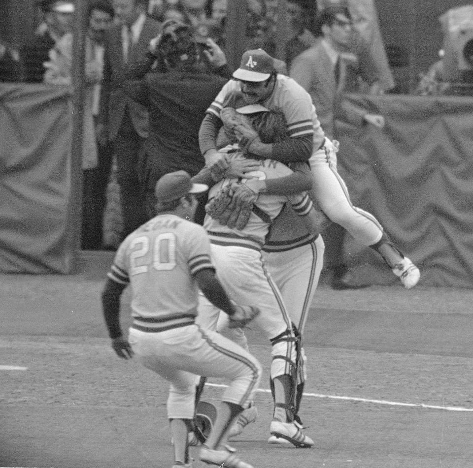 Oakland A's burst into celebration after the final out in the seventh and last game of the World Series against the Cincinnati Reds, Oct. 23, 1972, in Cincinnati.  Mike Regan (20) rushes in to join teammates Sal Bando, who jumps on catcher Dave Duncan and relief pitcher Rollie Fingers.