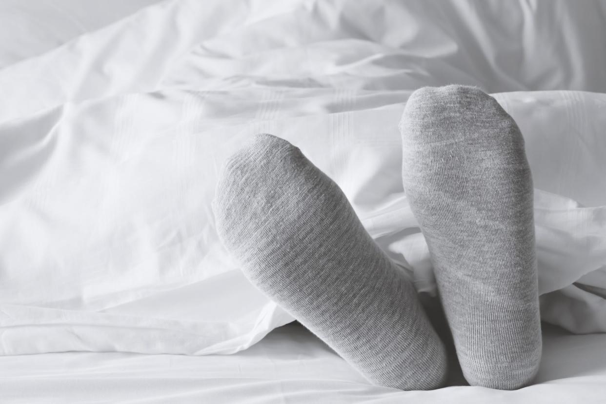 person wearing socks in bed