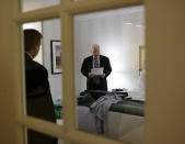 <p>Republican presidential hopeful Sen. John McCain, R-Ariz., reads over his election night speech in his hotel suite in Dallas, March 4, 2008. (Photo: Stephan Savoia/AP) </p>