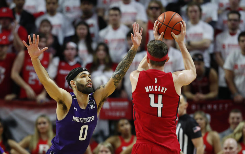Northwestern guard Boo Buie (0) defends against Rutgers guard Paul Mulcahy (4) during the first half of an NCAA college basketball game, Sunday, Mar.5, 2023 in Piscataway, N.J. (AP Photo/Noah K. Murray)