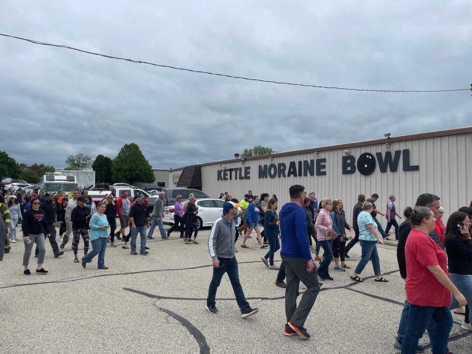 Parents gather in the parking lot of Kettle Moraine Bowl. Law enforcement in Slinger reported an arrest and no injuries after receiving a call of a student at Slinger Middle School with a gun Friday. The Washington County Sheriff's Department said parents should gather at a staging area there. Police did not recover a gun.