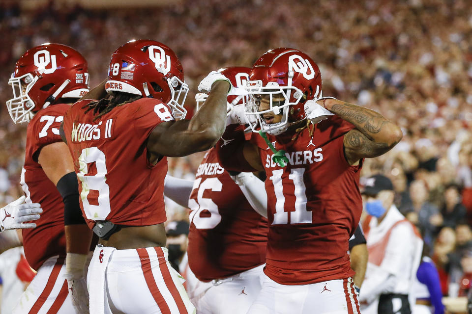 Oklahoma wide receiver Jadon Haselwood (11) celebrates after scoring a touchdown during the first half of an NCAA college football game against TCU, Saturday, Oct. 16, 2021, in Norman, Okla. (AP Photo/Alonzo Adams)