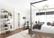 <p>This bedroom, designed by <a href="https://www.kellysuttoninc.com/" rel="nofollow noopener" target="_blank" data-ylk="slk:Kelly Sutton" class="link ">Kelly Sutton</a>, proves that sleek, modern style can co-exist with coziness when done right. Metallic furnishings and colors pair with sumptuous fabrics and a large area rug to create perfect harmony in this eclectic bedroom. </p>