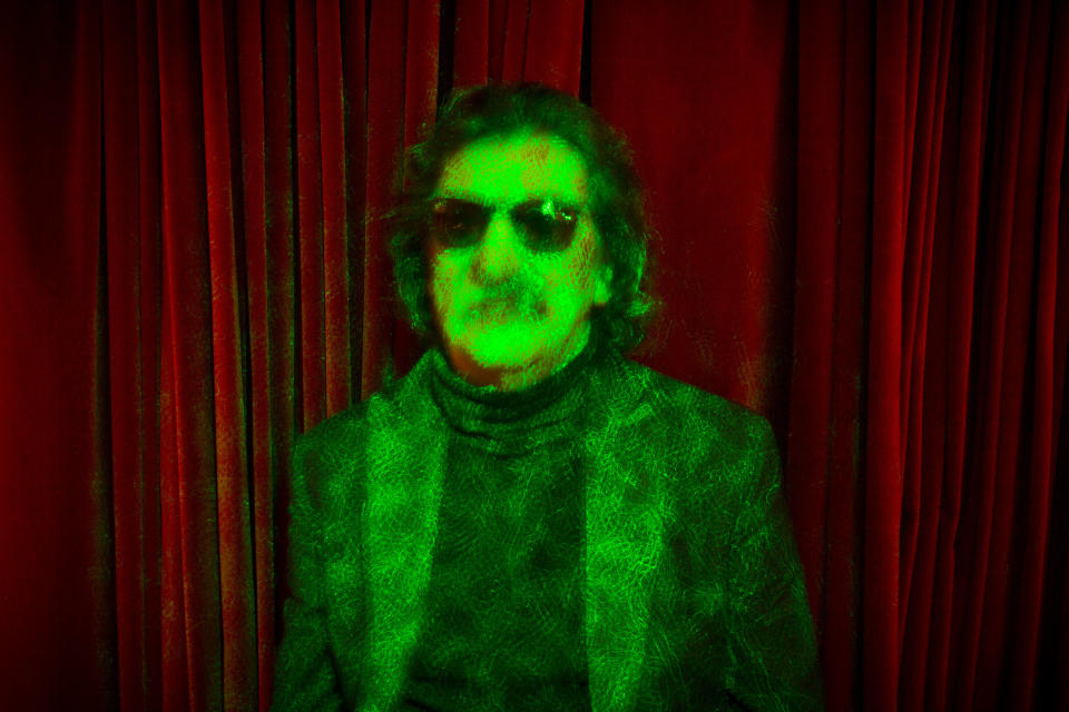 Argentine rock legend Charly Garcia poses for a portrait bathed in green laser lights in Buenos Aires, Argentina, Wednesday, Aug. 14, 2013. Garcia, who is 61 and has a vast career that defined and inspired the rock and pop music world in Latin America, will perform two shows at Teatro Colon, Argentina's landmark opera house, on Sept. 23 and 30. (AP Photo/Victor R. Caivano)