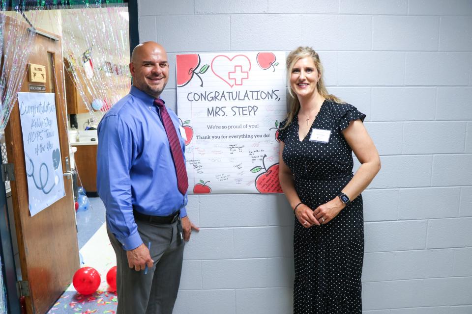 West Henderson High teacher Kelly Stepp poses with West Principal Luke Manuel after Stepp was named the 2024 Henderson County Public Schools Teacher of the Year.