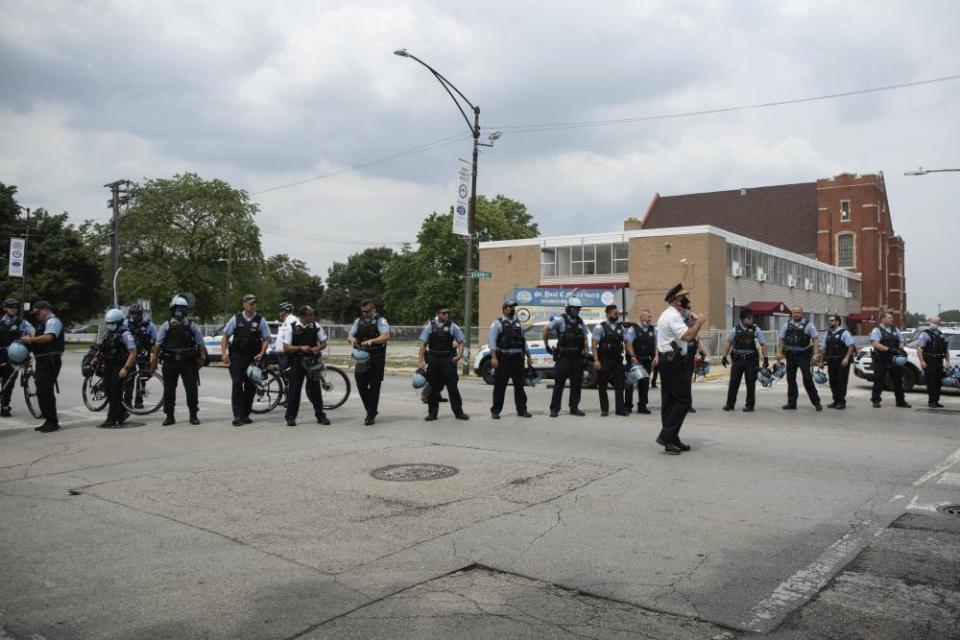 Police officers form a human barricade during an anti-police brutality protest, on 15 August in the Bronzeville neighborhood of Chicago.