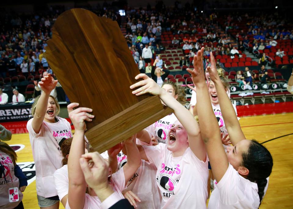 Members of the Cedar Rapids Xavier girls basketball team celebrate after beating Bishop Heelan during the Class 4A girls state basketball championship game at Wells Fargo Arena in Des Moines on Saturday, March 5, 2022.