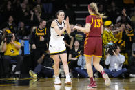 Iowa guard Caitlin Clark, left, celebrates in front of Iowa State guard Maggie Espenmiller-McGraw (13) after making a three-point basket during the second half of an NCAA college basketball game, Wednesday, Dec. 7, 2022, in Iowa City, Iowa. (AP Photo/Charlie Neibergall)