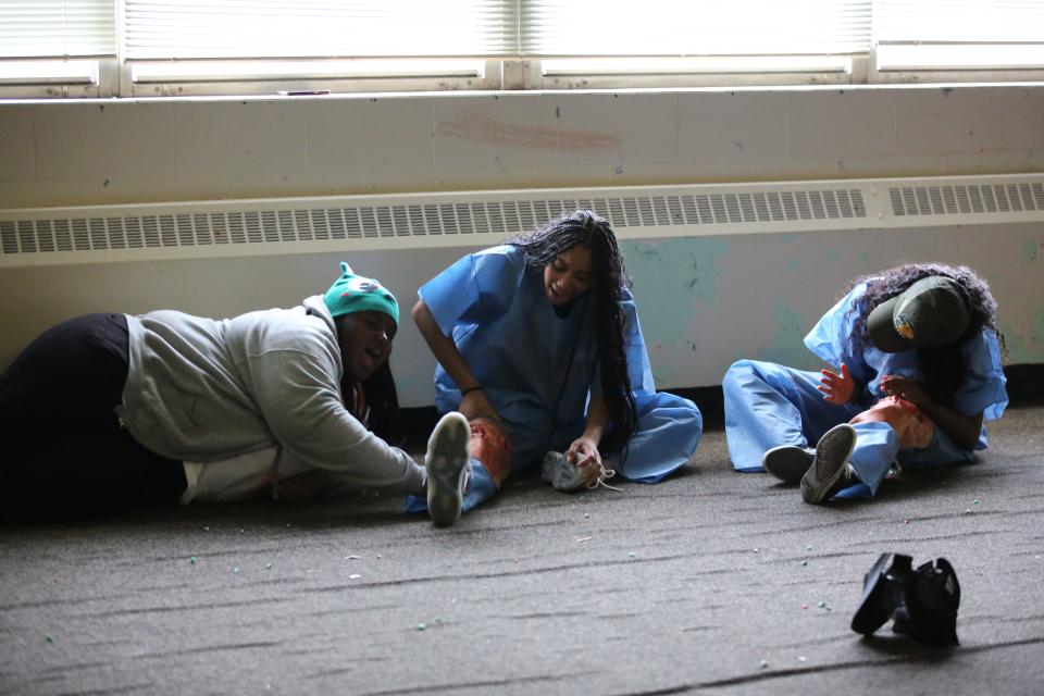 Three Gadsden County High School students scream and pretend to be injured during a joint police and fire rescue active shooter training, Dec. 4, 2023.