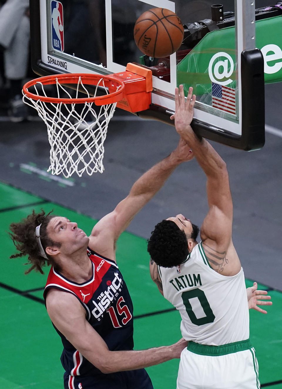 Boston Celtics forward Jayson Tatum (0) drives to the basket past Washington Wizards center Robin Lopez (15) during the first half of an NBA basketball Eastern Conference Play-in game, Tuesday, May 18, 2021, in Boston. (AP Photo/Charles Krupa)