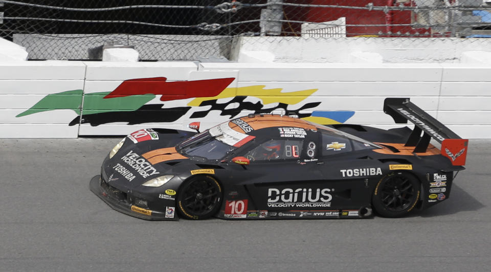 Jordan Taylor drives the Corvette DP through the front stretch during the final hours of the IMSA Series Rolex 24 hour auto race at Daytona International Speedway in Daytona Beach, Fla., Sunday, Jan. 26, 2014.(AP Photo/John Raoux)