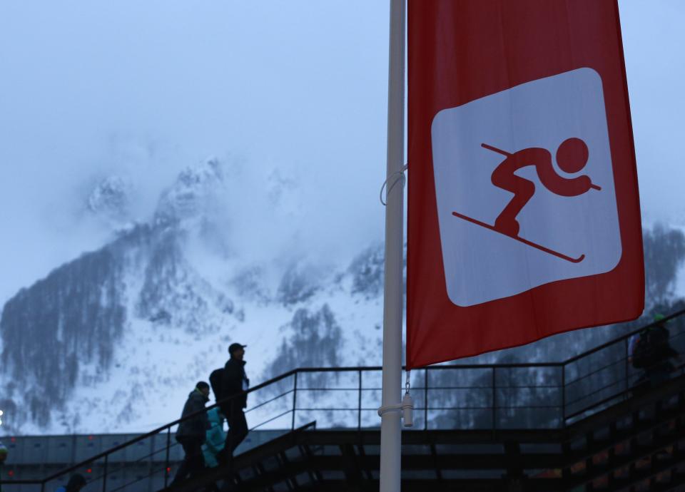 Spectators arrive for women's giant slalom in rainy conditions at the Sochi 2014 Winter Olympics, Tuesday, Feb. 18, 2014, in Krasnaya Polyana, Russia. (AP Photo/Gero Breloer)