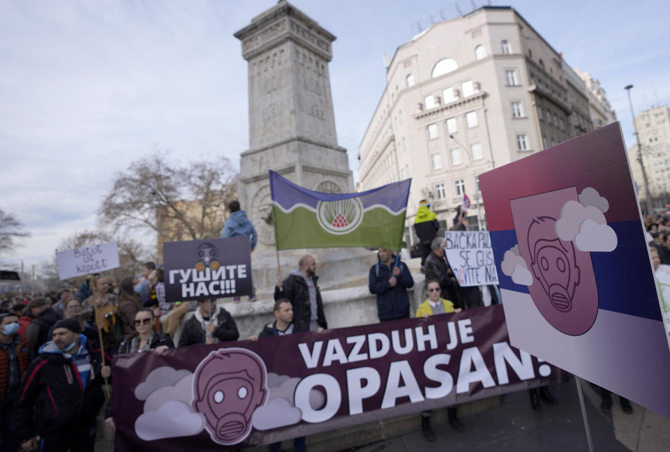 People hold banners during a protest for clean air in Belgrade, Serbia, Sunday, Nov. 28, 2021. Several thousand people have rallied in Belgrade for another environmental protest, a day after demonstrators blocked bridges and roads on several locations in Serbia, and scuffled with riot police who deployed to stop them. (AP Photo/Darko Vojinovic)