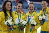 Blair Evans, left, along with teammates Kylie Palmer, Kelly Stubbins and Jade Nielsen pose for a picture with their silver medals after finishing second in the women's 4x200m freestyle relay at the FINA World Short Course Championships in Dubai on December 15, 2010. (PATRICK BAZ/AFP/Getty Images)