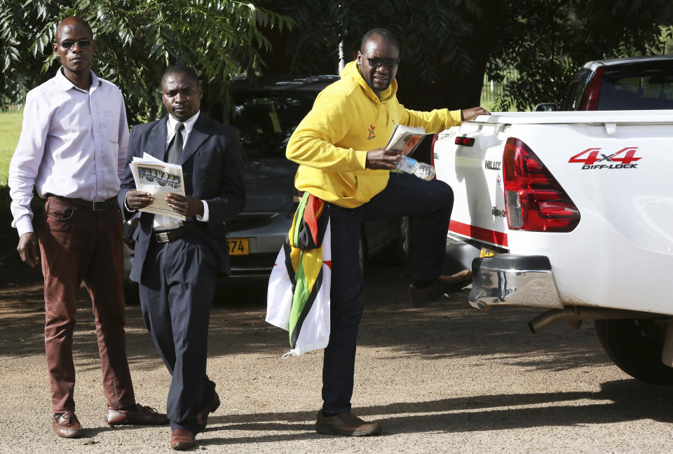 Evan Mawarire, right, pastor and activist arrives at the magistrates courts in Harare, Zimbabwe, Thursday, Jan, 17, 2019. A Zimbabwe Lawyers for Human Rights says in a statement that Mawarire who is among the more than 600 people arrested this week has been charged with subverting a constitutional government amid a crackdown on protests against a dramatic fuel price increase.(AP Photo/Tsvangirayi Mukwazhi)