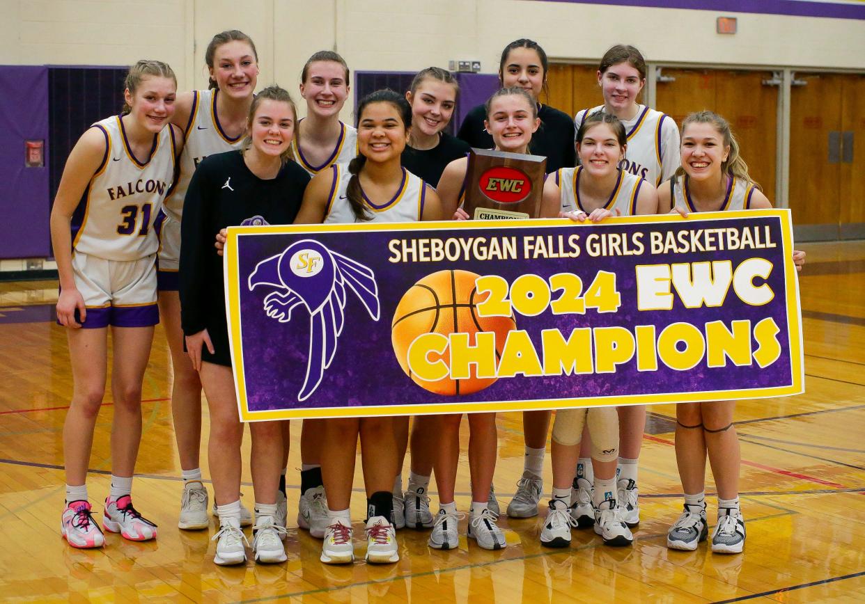 Sheboygan Falls players pose with a banner and their plaque honoring their Eastern Wisconsin Conference championship which was clinched in a win over over Valders on Thursday in Sheboygan Falls.