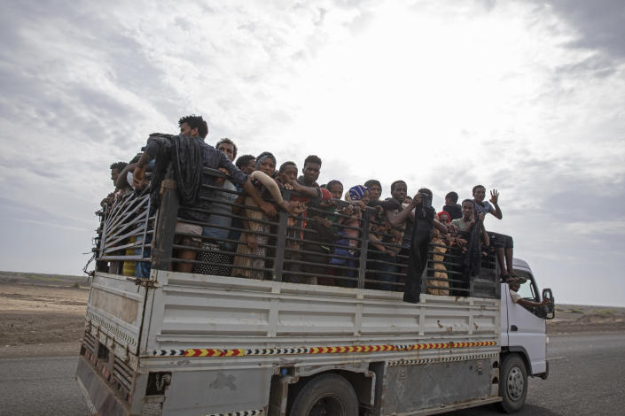 In this July 26, 2019 photo, Ethiopian migrants who had just arrived in Yemen from Djibouti stand in the back of a pickup truck to be taken to desert compounds known in Arabic as "hosh," in Ras al-Ara, Lahj, Yemen. "Out of every thousand, 800 disappear in the lockups," said a humanitarian worker monitoring the flow of migrants. (AP Photo/Nariman El-Mofty)