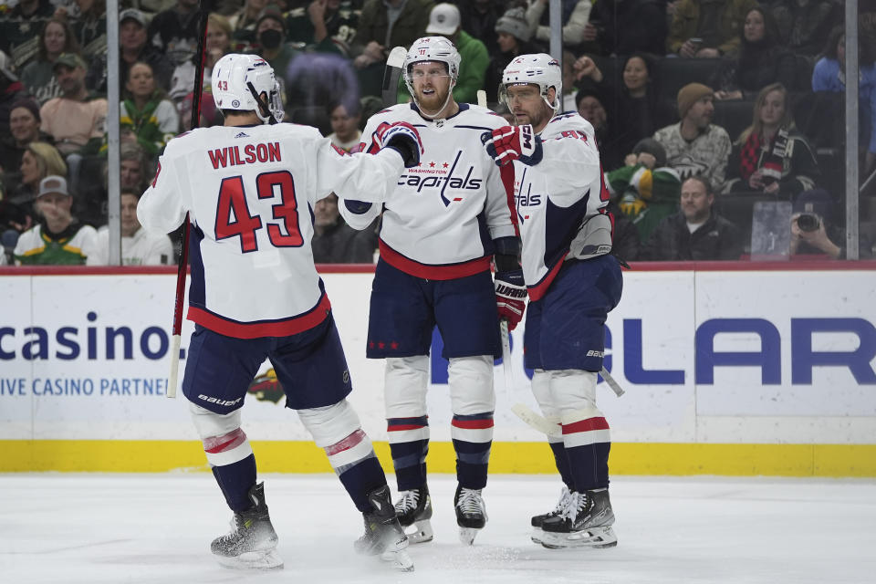 Washington Capitals right wing Anthony Mantha, center, celebrates with right wing Tom Wilson (43) and center Evgeny Kuznetsov after scoring during the second period of an NHL hockey game against the Minnesota Wild,Tuesday, Jan. 23, 2024, in St. Paul, Minn. (AP Photo/Abbie Parr)