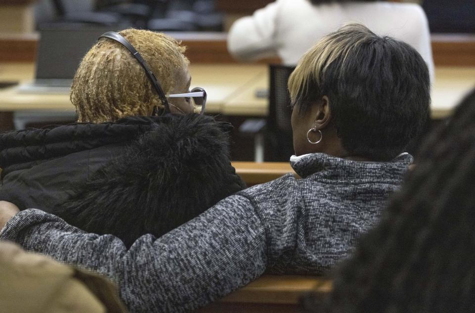 Manny Ellis' mother, Marcia Carter-Patterson, left, gets support from a woman before the verdicts are read by Pierce County Judge Bryan Chushcoff for the killing of Manny Ellis in Pierce County Superior Court Thursday, Dec. 21, 2023 in Tacoma, Wash. A jury cleared three Washington state police officers of all criminal charges Thursday in the 2020 death of Manuel Ellis, a Black man who was shocked, beaten and restrained face down on a Tacoma sidewalk as he pleaded for breath.(Ellen M. Banner/The Seattle Times via AP, Pool)