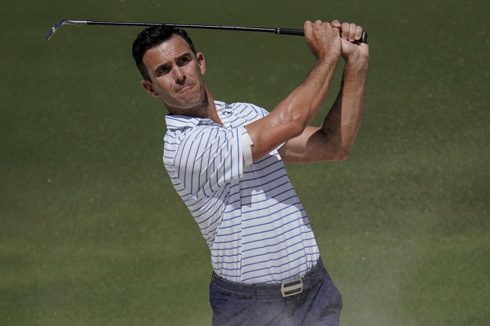 Billy Horschel hits from the bunker on the fifth hole during their fourball match at the Presidents Cup golf tournament at the Quail Hollow Club, Friday, Sept. 23, 2022, in Charlotte, N.C. (AP Photo/Julio Cortez)