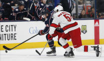 Columbus Blue Jackets' Gustav Nyquist, left, of Sweden, carries the puck across the blue line as Carolina Hurricanes' Trevor van Riemsdyk defends during the second period of an NHL hockey game Thursday, Jan. 16, 2020, in Columbus, Ohio. (AP Photo/Jay LaPrete)