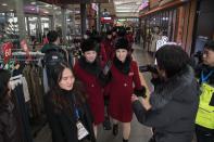 <p>North Korean cheerleaders arrive at a rest stop, or service station, as their bus convoy carrying a 280-member delegation on its way to the 2018 Pyeongchang winter Olympic games, makes its way past Gapyeong on February 7, 2018. </p>