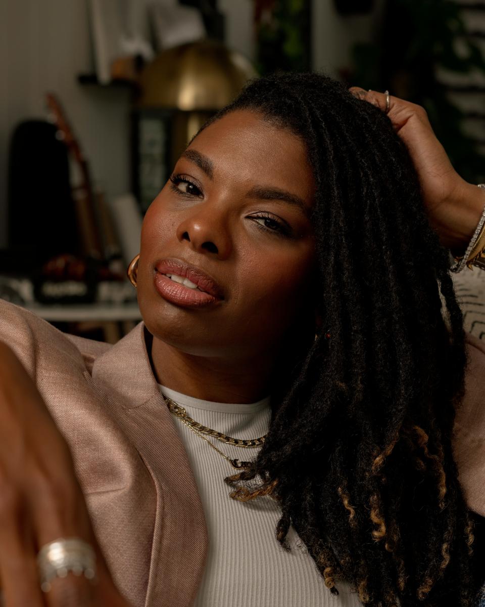 A close-up of Carmeon Hamilton, who is wearing a blush pink blazer over a white shirt.