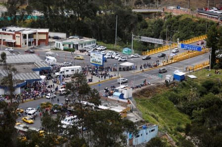 A general view of Venezuelans gather to cross into Ecuador from Colombia, as new visa restrictions from the Ecuadorian government took effect, at Rumichaca border bridge in Tulcan