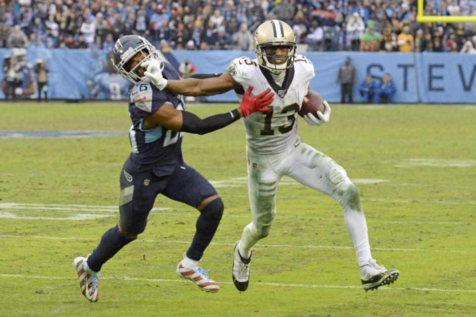 New Orleans Saints wide receiver Michael Thomas (13) pushes past Tennessee Titans cornerback Logan Ryan (26) after Thomas makes a reception in the second half of an NFL football game Sunday, Dec. 22, 2019, in Nashville, Tenn. The catch gave Thomas the single-season pass reception record. (AP Photo/Mark Zaleski)
