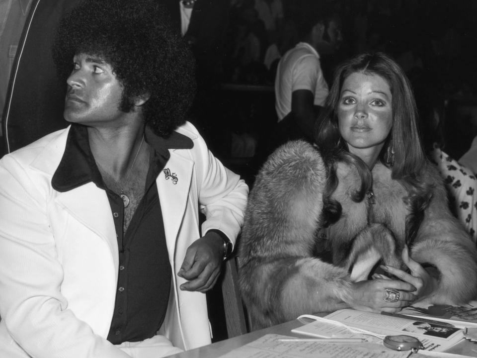 American actor Priscilla Presley sits with her boyfriend, karate instructor Mike Stone, at a kung fu tournament at the Beverly Hills High School, California.