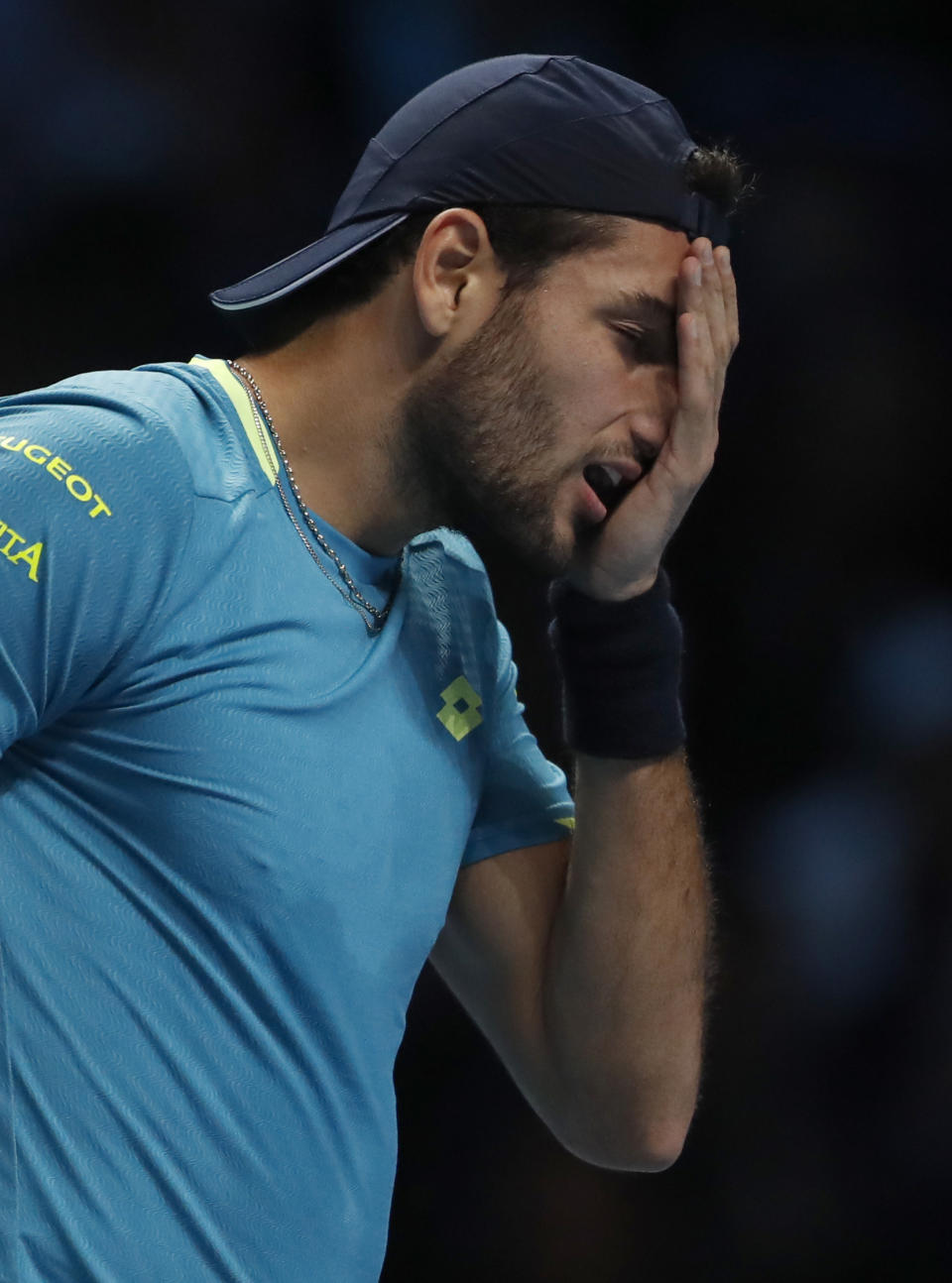 Italy's Matteo Berrettini reacts after missing a shot as he plays against Serbia's Novak Djokovic during their ATP World Tour Finals singles tennis match at the O2 Arena in London, Sunday, Nov. 10, 2019. (AP Photo/Alastair Grant)