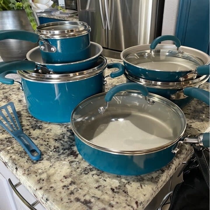 the blue non-stick cookware set on a kitchen countertop