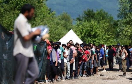 Migrants wait for food and clothes at the migrant camp Vucjak in Bihac area