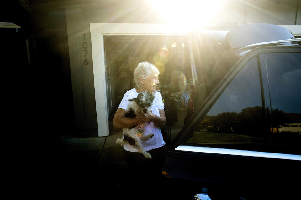 Barbara Sereni helps a neighbor evacuate her dog as a wildfire called the Kincade Fire burns nearby on Saturday, Oct. 26, 2019, in Healdsburg, Calif. (AP Photo/Noah Berger)