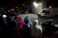 Family members of inmates stand outside Topo Chico Prison as an ambulance leaves the compound in Monterrey, Mexico, February 11, 2016. REUTERS/Daniel Becerril