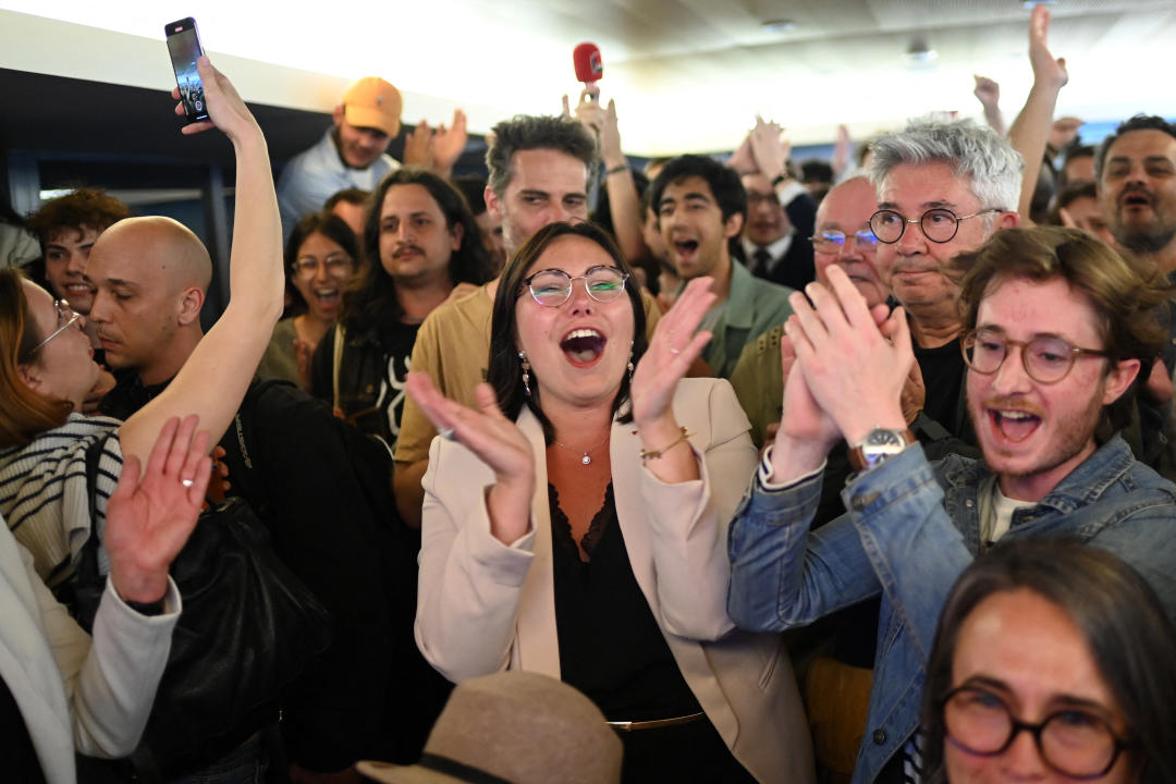 Supporters of the left wing coalition Nouveau Front Populaire (NFP) react after the first results of the second round of France's legislative election during an election night event in Rennes on July 7, 2024. A broad left-wing coalition was leading a tight French legislative election, ahead of both President's centrists and the far right with no group winning an absolute majority, projections showed. (Photo by Sebastien SALOM-GOMIS / AFP) (Photo by SEBASTIEN SALOM-GOMIS/AFP via Getty Images)