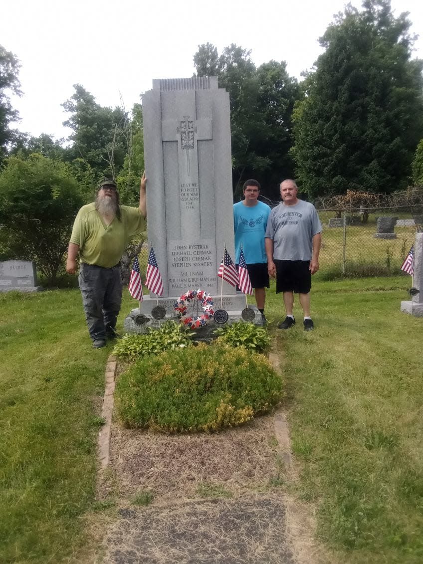 From left, Samuel A. Kucharek, John Beblavy and Robert Beblavy stand by the Veterans' Monument at Slovak Lutheran Cemetery, Johnson City