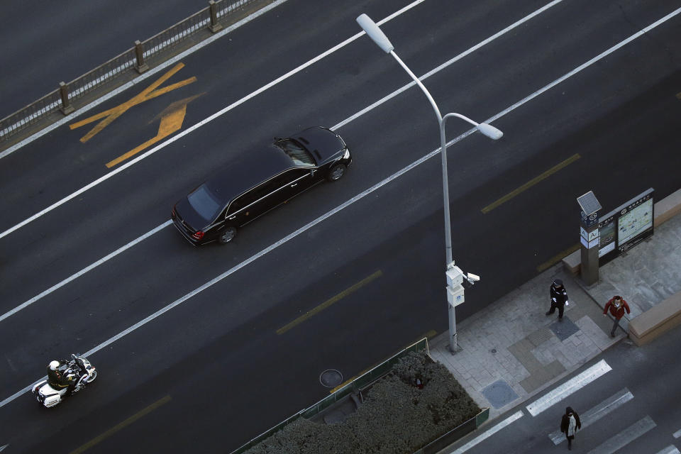 A policeman directs people to walk away as a Mercedes limousine with a golden emblem, similar to one North Korean leader Kim Jong Un has used previously, is escorted by motorcades traveling past Chang'an Avenue in Beijing, Wednesday, Jan. 9, 2019. North Korean state media reported Tuesday that Kim is making a four-day trip to China in what's likely an effort by him to coordinate with his only major ally ahead of a summit with U.S. President Donald Trump that could happen early this year. (AP Photo/Andy Wong)