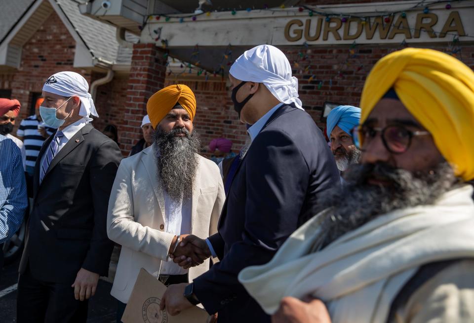 Rep. Andre Carson (center, back to camera) greets members of the local Sikh community during the annual Vaisakhi gathering Sunday, April 18, 2021, at Sikh Satsang gurdwara on the southeast side of Indianapolis. The holiday celebration was accompanied by a memorial service for victims of the recent shooting at the FedEx Ground Plainfield Operations Center on Indianapolis' southwest side, which killed eight people, four of whom were members of the Sikh community. 