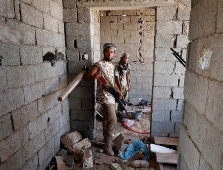 Fighters of Libyan forces allied with the U.N.-backed government stand in a house during a battle with IS fighters in Sirte, Libya, July 21, 2016. REUTERS/Goran Tomasevic